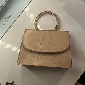 Like dreams clutch with chain crossbody strap.